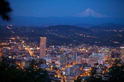 The Portland skyline at night, with Mount Hood in the background. Travel Portland