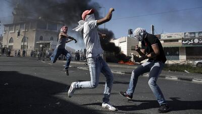 As word spread of the Palestinian teenager’s disappearance and the discovery of a body, hundreds of Arab youths blocked Jerusalem’s light railway. Ahmad Gharabli/AFP Photo
