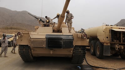 Saudi soldiers are seen on top of their tank deployed at the Saudi-Yemeni border, in Saudi Arabia's southwestern Jizan province. AFP