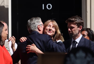 Outgoing prime minister Keir Starmer hugs former chancellor Rachel Reeves after delivering a farewell speech. EPA