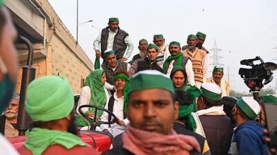 Farmers are seen in a tractor trolley near a police road block stopping them from marching to New Delhi to protest against the central government's recent agricultural reforms AFP