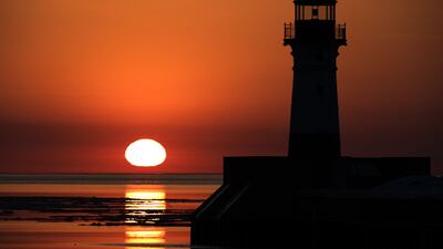 The sun rises over Lake Superior and the Duluth North Pier Lighthouse in Duluth, Minnesota. AFP