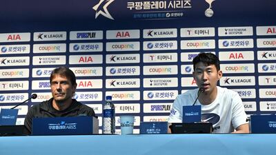Tottenham Hotspur's South Korean striker Son Heung-min speaks as head coach Antonio Conte listens. AFP