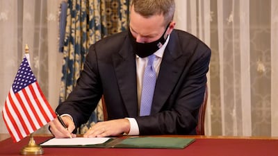 An unidentified official signs a memorandum of understanding during a visit by Israeli envoys to Rabat, Morocco. REUTERS