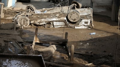 Buildings and vehicles were damaged by the floodwaters and subsequent mudslides. AP Photo