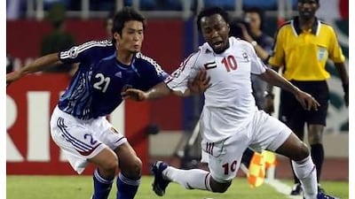 Ismail Matar is pulled down by Japan's Akira Kaji (left) during the 2007 Asian Cup.