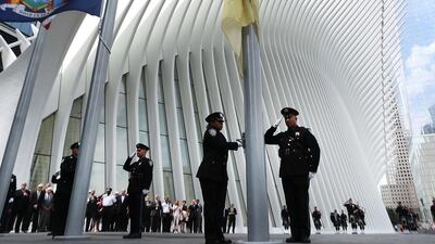 Port Authority Police participate in a flag raising ceremony outside of the newly opened Westfield World Trade Center shopping mall. The 350,000 square-foot mall, which will feature more than 100 retail stores, opens nearly 15 years after the September 11 terrorist attacks at the World Trade Center. Spencer Platt / Getty