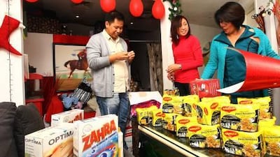 Rex Maray, Fretsyl Egnora and Wilma Villaneva, members of a non-profit organisation, wrap gifts ahead of the Christmas Celebrations at their residence in Dubai.
