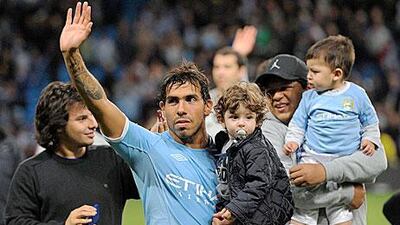 Tevez, during a lap of honour last night at Manchester, has said he wants more time with his daughters.