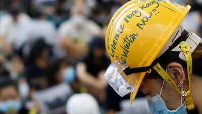 An anti-extradition bill protester wears a helmet at the arrival hall. Reuters