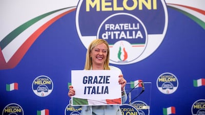 Giorgia Meloni, leader of the Fratelli d'Italia (Brothers of Italy) holds a "thank you Italy" sign during a press conference at the party electoral headquarters in Rome. Getty