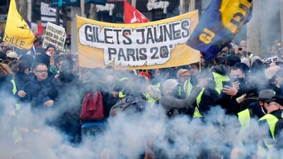 Protesters wave French regional flags on the Champs-Elysees in Paris. AFP