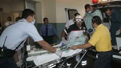 Paramedics wheel a baby to an emergency room. The victims died of mostly from smoke inhalation.