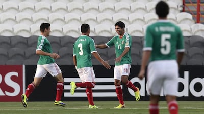 Mexico's Ivan Ochoa, No 11, celebrates with his teammates after scoring the opening goal against Argentina in the Fifa Under 17 World Cup semi-finals on Tuesday. Hassan Ammar / AP Photo