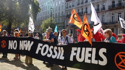 Demonstrators in London hold a banner during a global protest to end fossil fuels on September 16. Reuters