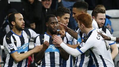 Vurnon Anita celebrates with team mates after scoring the equalising goal for Newcastle. Andrew Yates / Reuters