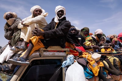 Sudanese refugees prepare to return to their temporary shelter in Chad. Getty Images