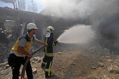 Syrian firefighters try put out a fire in a building that was hit by reported Russian air strikes in the rebel-hold town of Jadraya, about 35 kilometres southwest of the city of Idlib. AFP