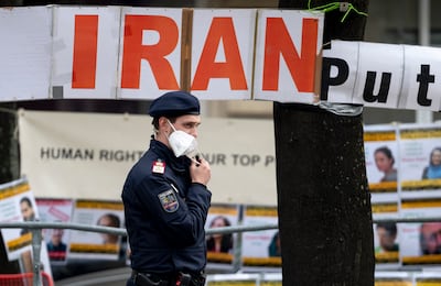 A police officer patrols in front of banners, put up by an Iranian opposition group, at the Grand Hotel Wien during talks in Vienna in April this year. AFP