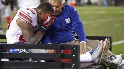 New York Giants wide receiver Victor Cruz leaves the field on a cart after injuring his knee against the Philadelphia Eagles on Sunday. Matt Rourke / AP / October 12, 2014