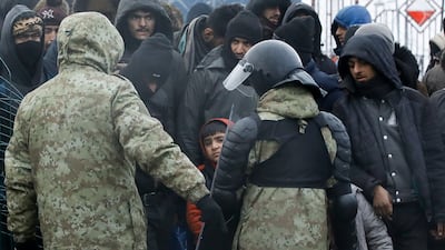 Belarusian law enforcement personnel in a migrant camp on the border with Poland. Reuters