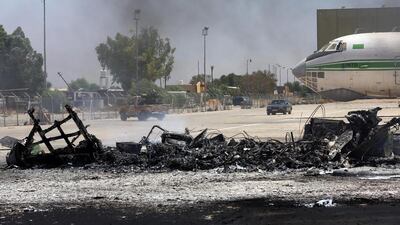 A picture taken on July 16, 2014, shows the remains of a burnt airplane at the Tripoli international airport in the Libyan capital. Mahmud Turkia/AFP Photo