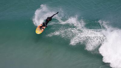 Surfer Neil Webster rides a wave in the Atlantic Ocean off Noordhoek, Cape Town, South Africa, on February 3, 2017. Nic Bothma / EPA