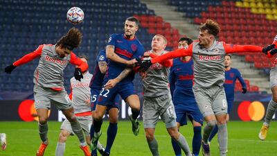 Atletico Madrid's Mario Hermoso, second left, heads home their opening goal in Austria. Reuters