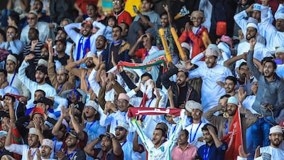 Fans hold up signs to support Qatar during the AFC Asian Cup final against Japan at Zayed Sports City Stadium in Abu Dhabi. Victor Besa / The National