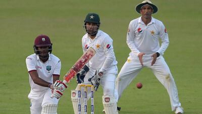 West Indies' batsman Kraigg Brathwaite, left, plays a shot as Pakistani wicketkeeper Sarfraz Ahmed and teammate Younis Khan look on. Aamir Qureshi / AFP