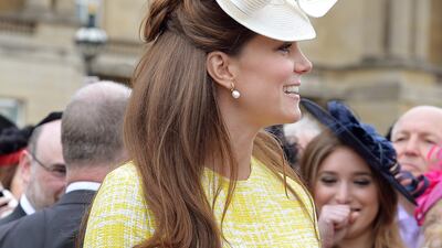 Catherine, Duchess of Cambridge, in yellow Emilia Wickstead, attends a garden party in the grounds of Buckingham Palace on May 22, 2013. Getty Images