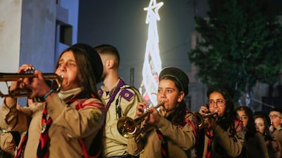 A band plays during the lighting ceremony of a Christmas tree at the Mar Elias Church in Damascus, months after it was the site of a deadly attack. AP