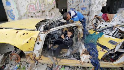 Palestinian children play next to buildings destroyed during Israel's war on Gaza last summer on January 27, 2015. Mohammed Abed/AFP Photo