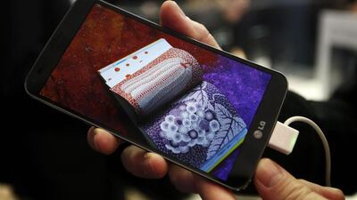 A model holds a curved G Flex smartphone by LG Electronics during the Mobile World Congress in Barcelona. Gustau Nacarino / Reuters