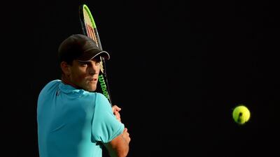 Vasek Pospisil returns a shot to Mackenzie McDonald during the Miami Open first round. AFP