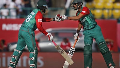 Bangladesh’s Tamim Iqbal, left and Mahmudullah cheer each other as they bat during the ICC World T20 2016 cricket tournament against Netherlands at the Himachal Pradesh Cricket Association (HPCA) stadium in Dharmsala, India, Wednesday, March 9, 2016. (AP Photo/Tsering Topgyal)