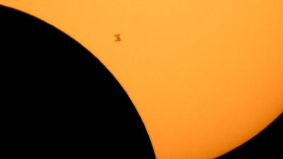 The International Space Station silhouetted against a partial eclipse. AP