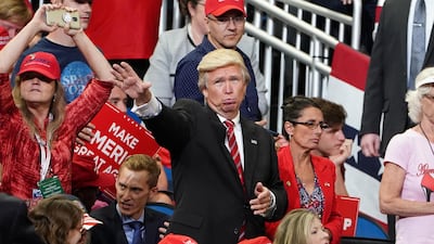 A man dressed as Donald Trump waves before a campaign kick off rally at the Amway Center in Orlando, Florida. Reuters
