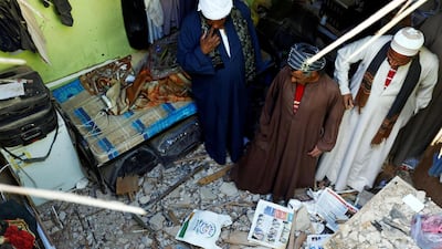 People check the damage created by debris. Faisal Al Nasser / Reuters