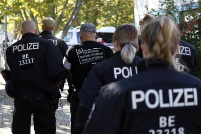 A protestor is detained by police officers during a demonstration of the far-right party The Third Path in Berlin, Germany, October 3, 2020. Reuters