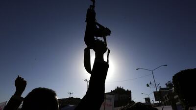 A weapon is held up in the air on the streets of Sanaa on Friday. Yahya Arhab / EPA