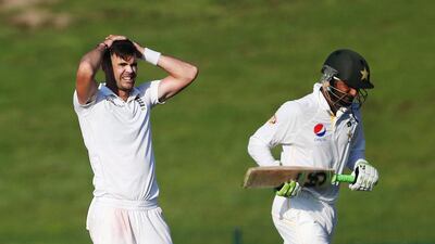 England's James Anderson, left, looks dejected as Shoaib Malik goes through for a run. Jason O'Brien / Reuters