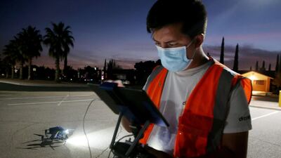 DroneUp pilot Andrew Holbert prepares to launch a drone to deliver a Covid-19 self collection test kit to a home, after being ordered from Walmart by a resident, amid a Covid-19 surge in El Paso, Texas. Residents who live within 1.5 miles of the Walmart Supercenter in East El Paso are eligible for the free kits as part of a drone delivery pilot program. AFP