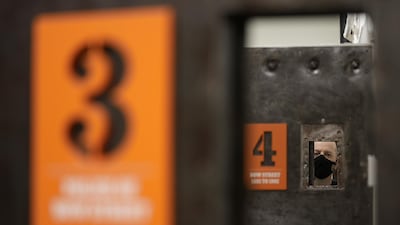 Looking though cell doors in the new Bow Street Police Museum in London which opened to the public on Friday May 28. AP Photo/Kirsty Wigglesworth.