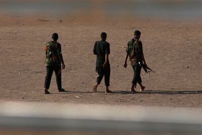 Armed men in Khartoum on Monday, as fighting between two rival generals persists. AFP