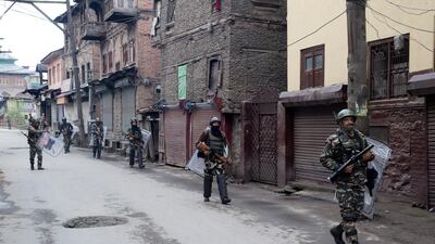 Indian paramilitary soldiers patrol a deserted street in Srinagar. AP Photo