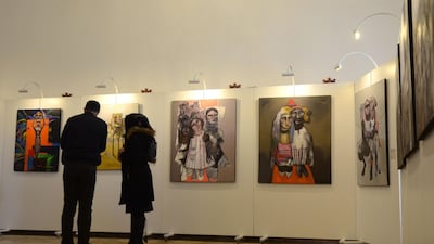 Iraqis tour a contemporary art exhibition at one of the halls of the national museum of the northern Iraqi city of Mosul. AFP