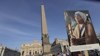 A nun holds a photo of Mother Teresa at the canonisation ceremony in St Peter’s Square at the Vatican on September 4, 2016. Alessandra Tarantino / AP Photo