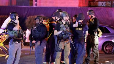 Police officers stand at the scene of a shooting near the Mandalay Bay resort and casino on the Las Vegas Strip. John Locher / AP Photo