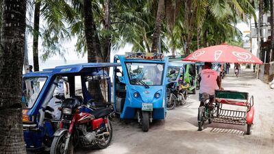 Tricycles and e-trikes wait for daytrippers.